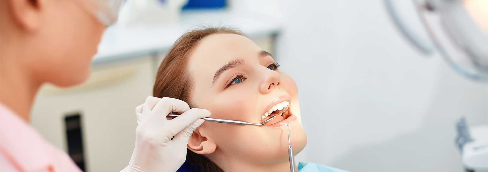 Dentist checking cavities