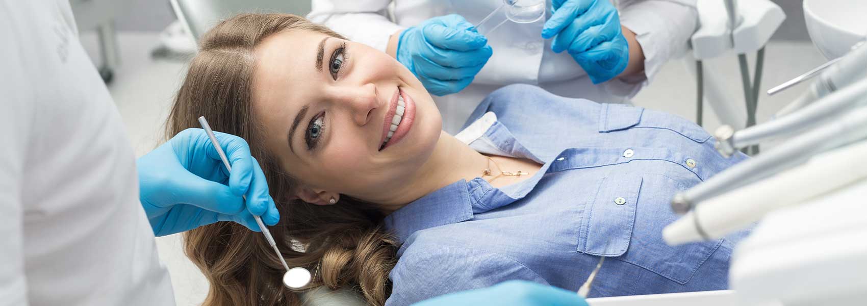 Patient smiling while teeth cleaning treatments
